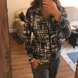 Black and white cinched-waist rain jacket